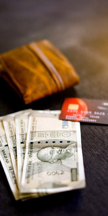 Cash, credit card and wallet on a table.